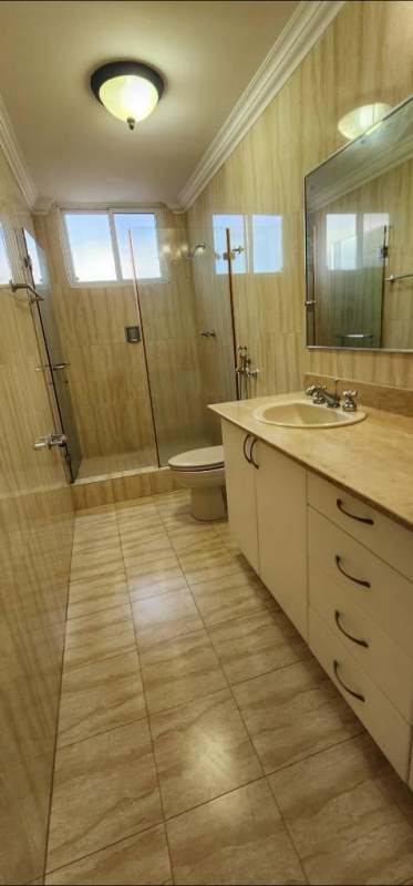 Modern beige tile bathroom with glass walk-in shower and vanity in PH Brisas Heights Brisas del Golf Panama