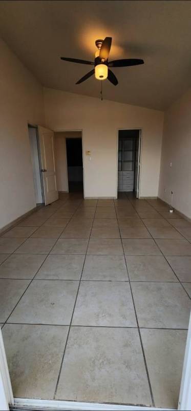 Bedroom with beige tiles and ceiling fan in PH Brisas Heights Brisas del Golf Panama