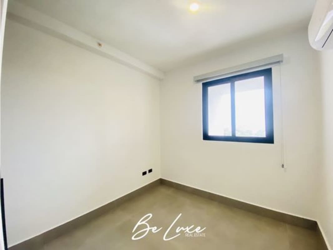 Bedroom with large windows and city view in Panama City PH Victory Sport