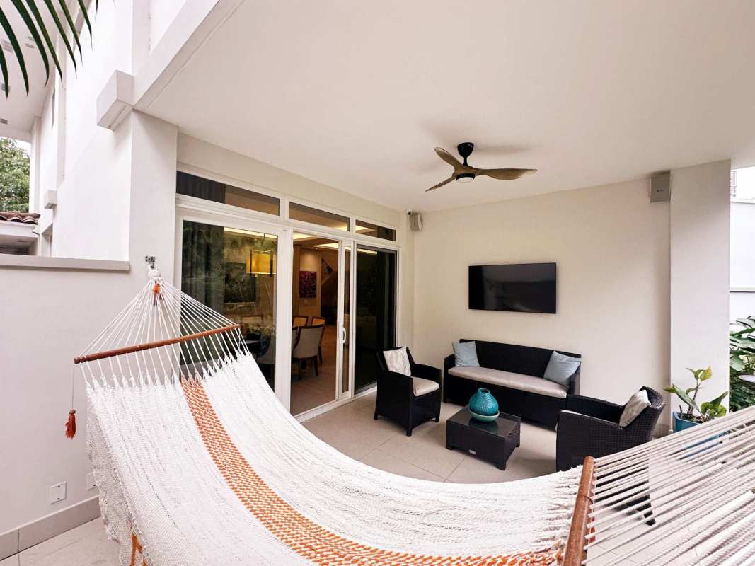 Spacious backyard garden with tropical palms at luxury house The Grove Santa María Golf Panama