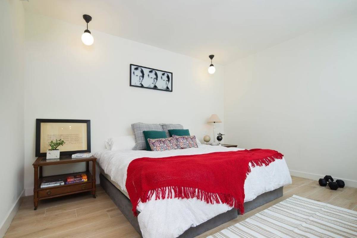 Living room with exposed beams, wood flooring, French doors PH San Felipe Casco Viejo Panama
