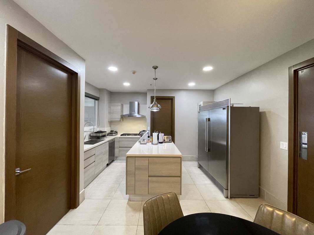 Spacious Italian kitchen with island, stainless appliances marble countertops at The Reserve Santa Maria Panama
