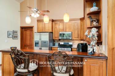 Outdoor terrace with tile floors overlooking gardens and mountains in Boquete home