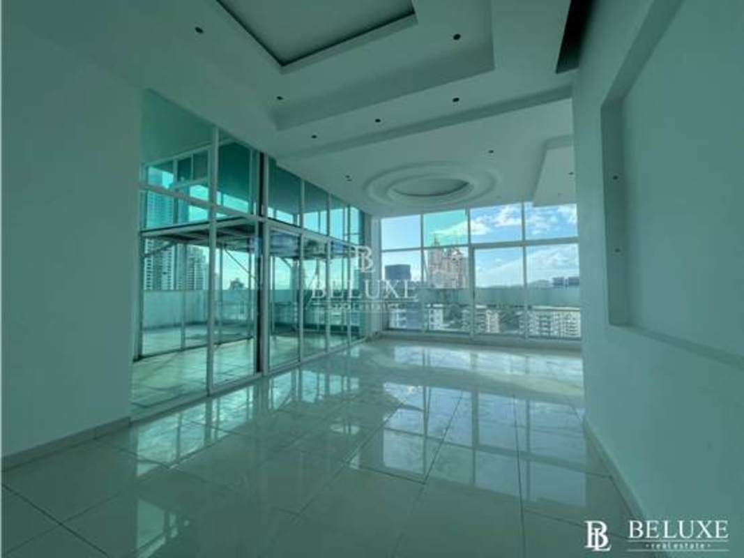 Living room with expansive windows and city views at PH Kubic El Cangrejo Panama