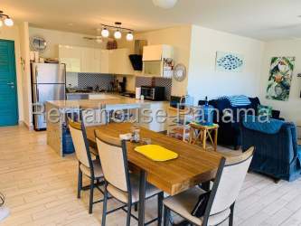 Kitchen and dining area with modern appliances in beachfront condo Nueva Gorgona