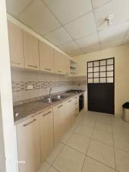 Contemporary kitchen with granite countertops, wood cabinetry, built-in oven in Costa Verde Panama house for sale