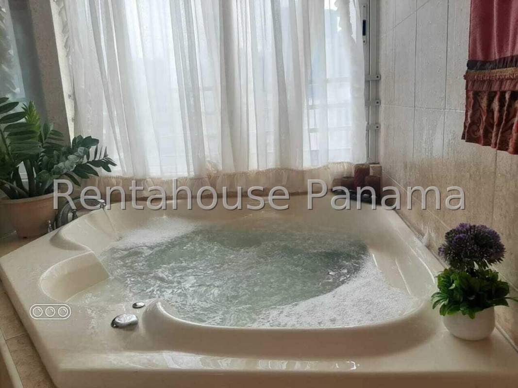 Kitchen with wooden cabinets, granite countertops, stainless appliances in PH Marina Park Panama