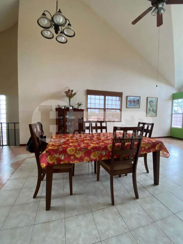 Spacious living room with vaulted ceiling and spiral staircase in La Montañesa house Panama