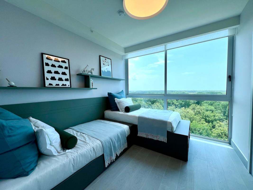 Modern bathroom with marble finishes and glass shower in The Ivy Panama