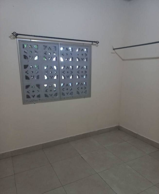 Bathroom with tiled walls, striped curtain, sink vanity and toilet in Nuevo Tocumen apartment