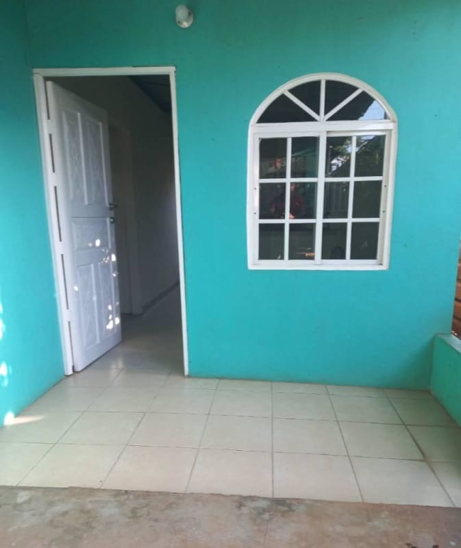 Bedroom with tile floor and decorative concrete window grille at Nuevo Tocumen rental Panama