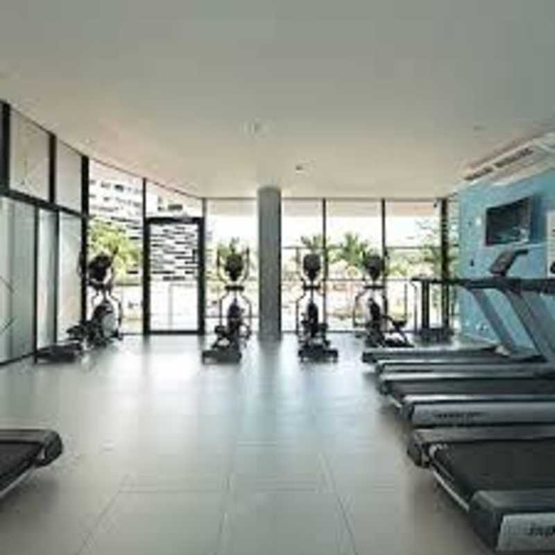 Condominium gym with cardio equipment, large windows PH Condado Country Club Panama