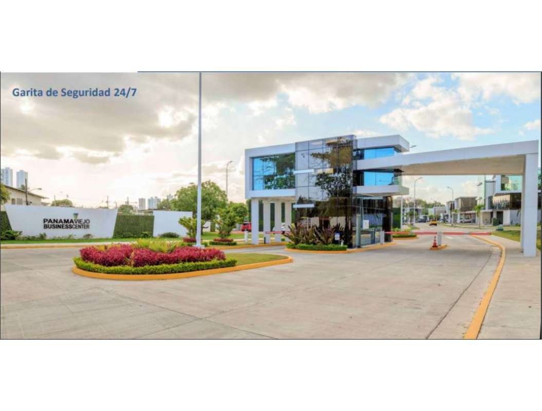 Contemporary commercial buildings with large glass windows and private parking at Panama Viejo Business Center