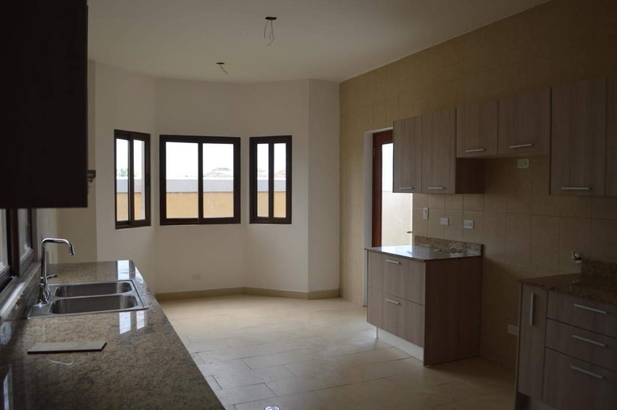 Contemporary kitchen with granite counters, cabinets, natural light in Costa Sur Panama
