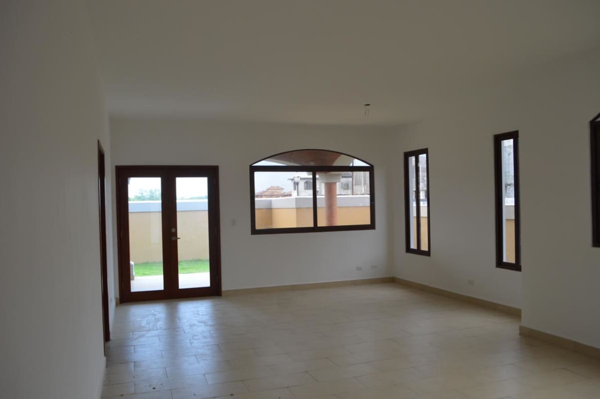 Large living dining area with natural light and terrace access in Costa Sur Panama house