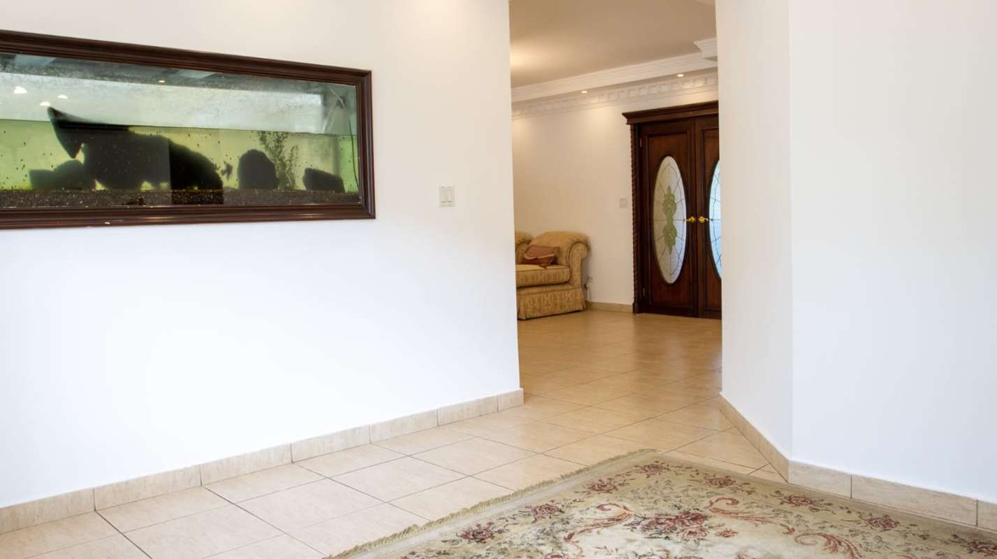 Entry area of luxury home featuring aquarium decorative doors in Costa del Este