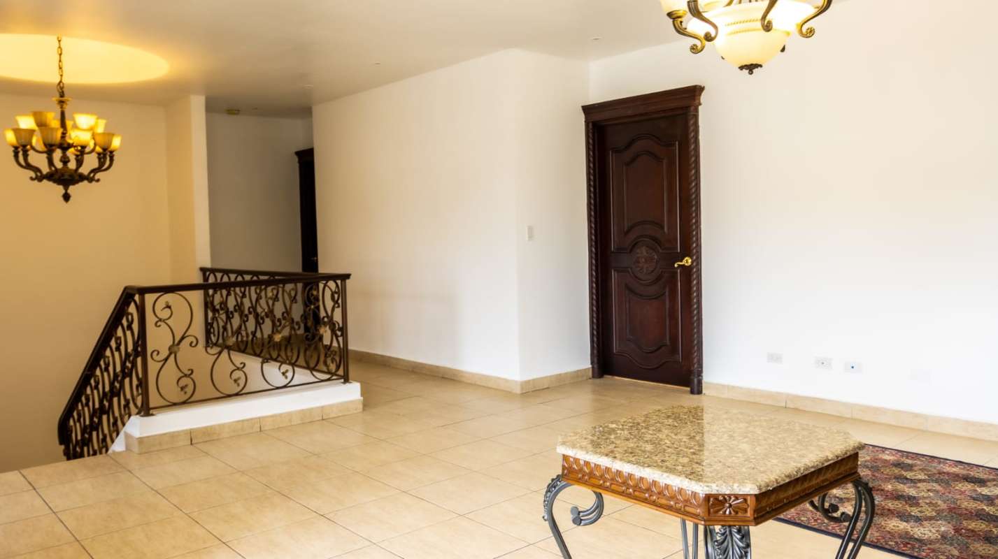 Large living area with chandelier, natural light and traditional finishes in Costa del Este house