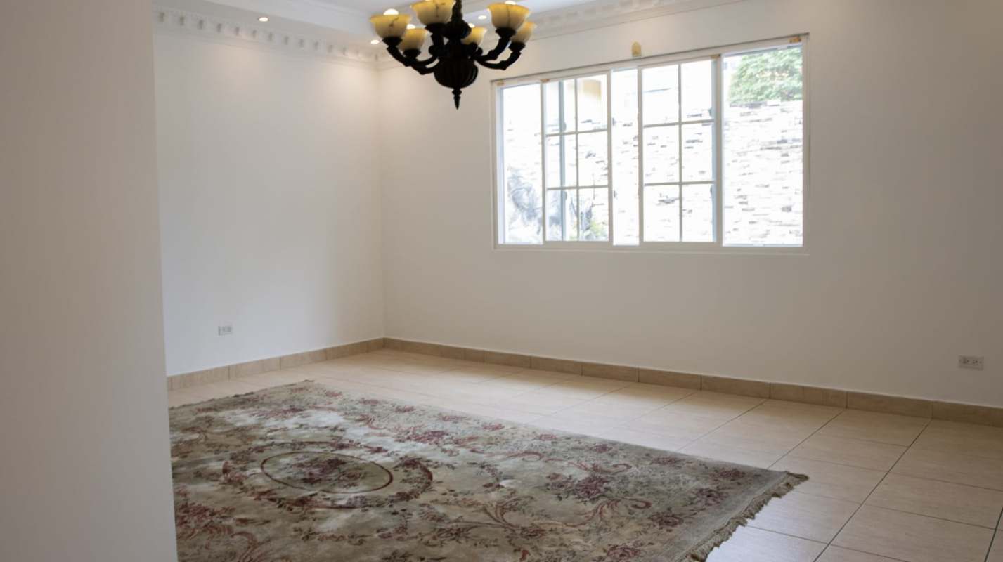 Empty living room with wood floors and large window in Costa del Este luxury home