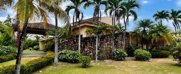 Outdoor tropical patio bar with thatched roof, rustic tiles, garden views in Coronado Panama