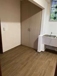 Living and dining area with wooden floors, large windows, ceiling fan in furnished rental David Panama