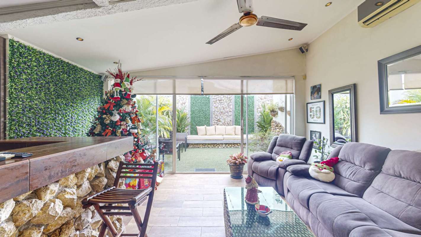 Rustic traditional open living dining space with natural light and tile floors in Chanis La Fontana Panama