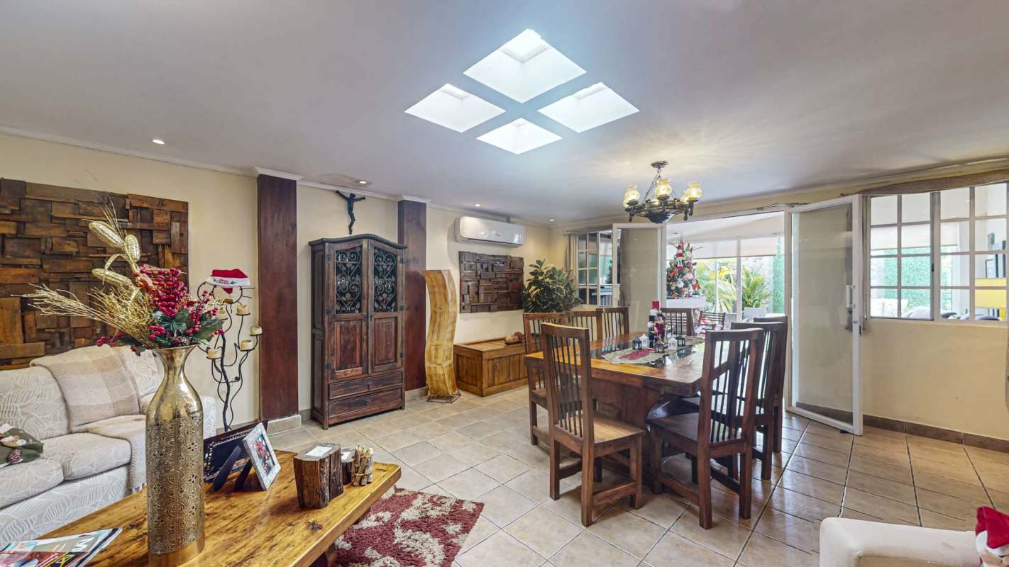 Bright minimalistic bedroom with wood flooring, ceiling fan, AC, large windows in La Fontana Chanis Panama
