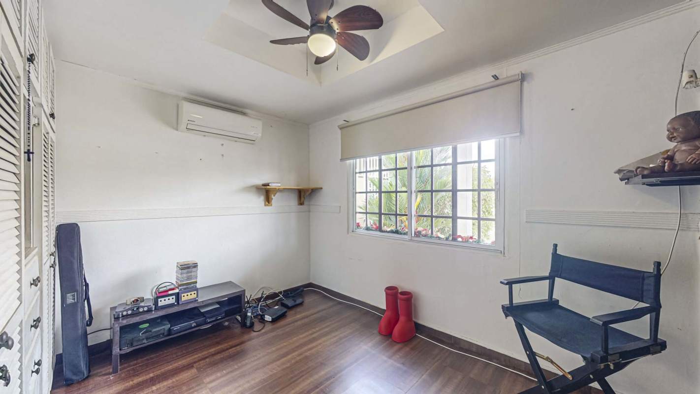 Rustic style spacious kitchen with wood cabinets, granite countertops and ceiling fan in Chanis Panama