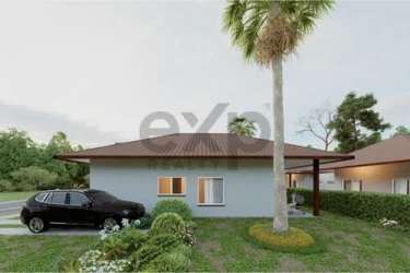 Exterior of twin single-story Bali inspired villas with landscaped garden at La Zahina near Playa Venao