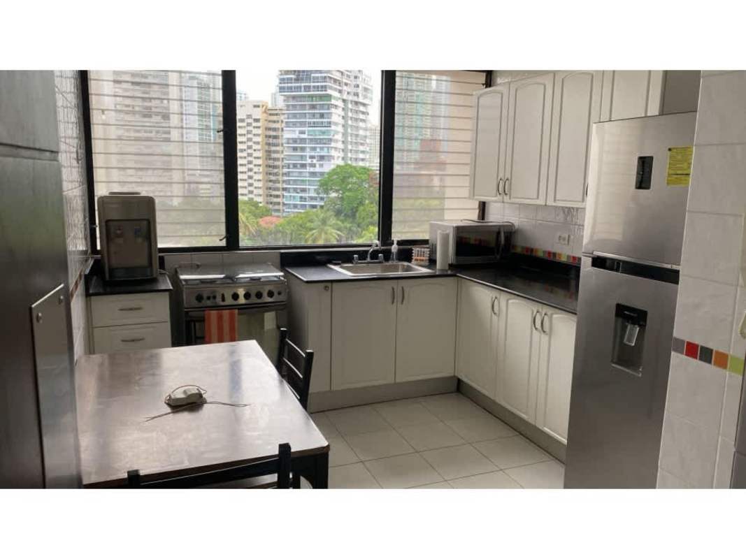Modern kitchen with white cabinets, black countertops, city view window in PH Paitilla Point