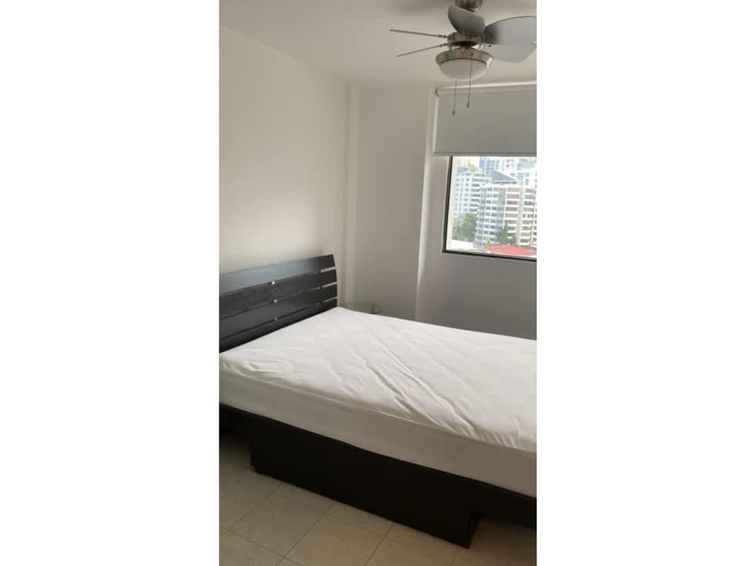 Minimalist bedroom with city view, fan and natural light in Punta Paitilla apartment rental