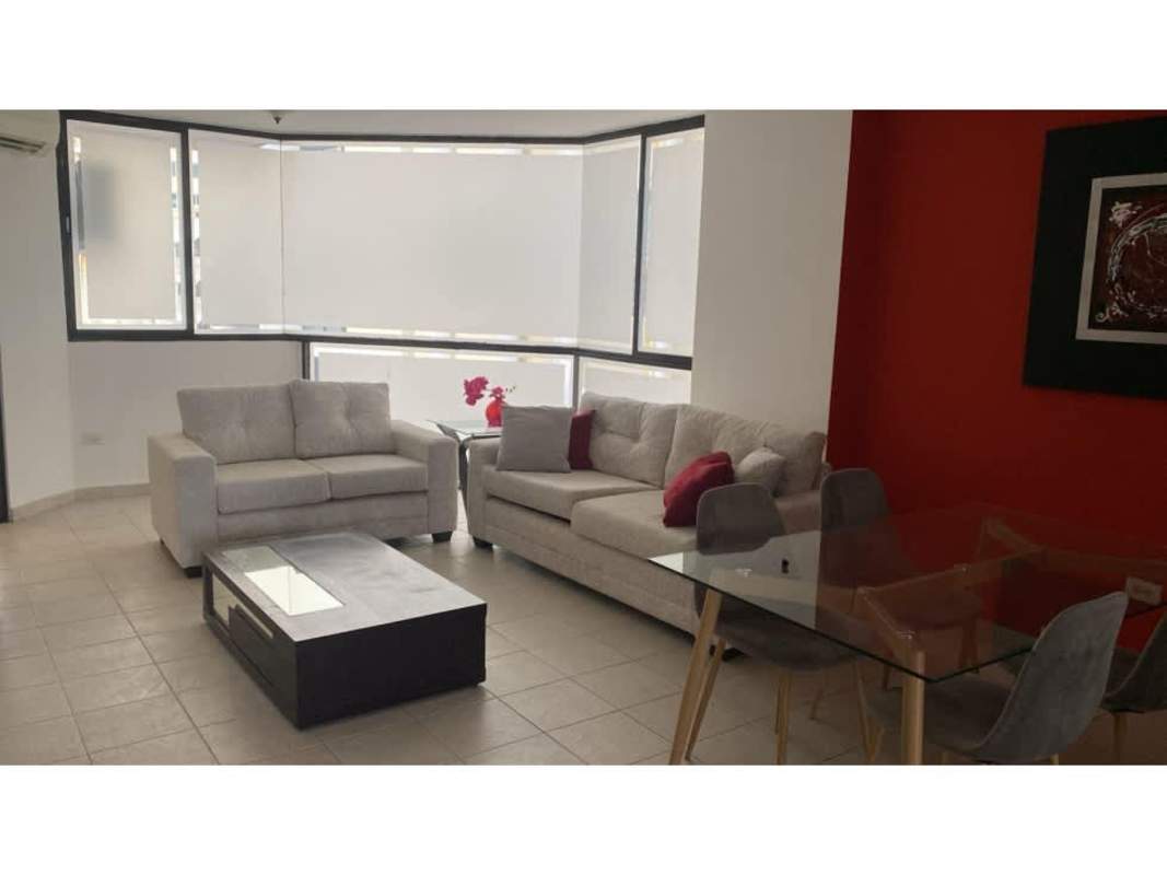 Minimalist master bedroom with large window and black bedframe in PH Paitilla Point Panama