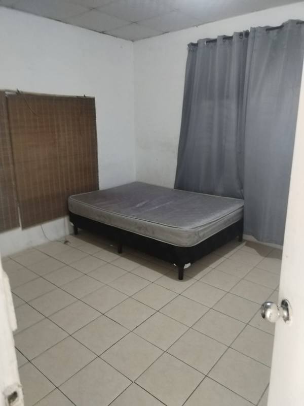 Simple bedroom with tiled floor, mattress, window blinds in Ciudad Radial Panama apartment