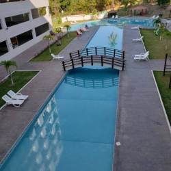 Ground-level swimming pool surrounded by sun deck, PH Coronado Bay beachfront apartment complex