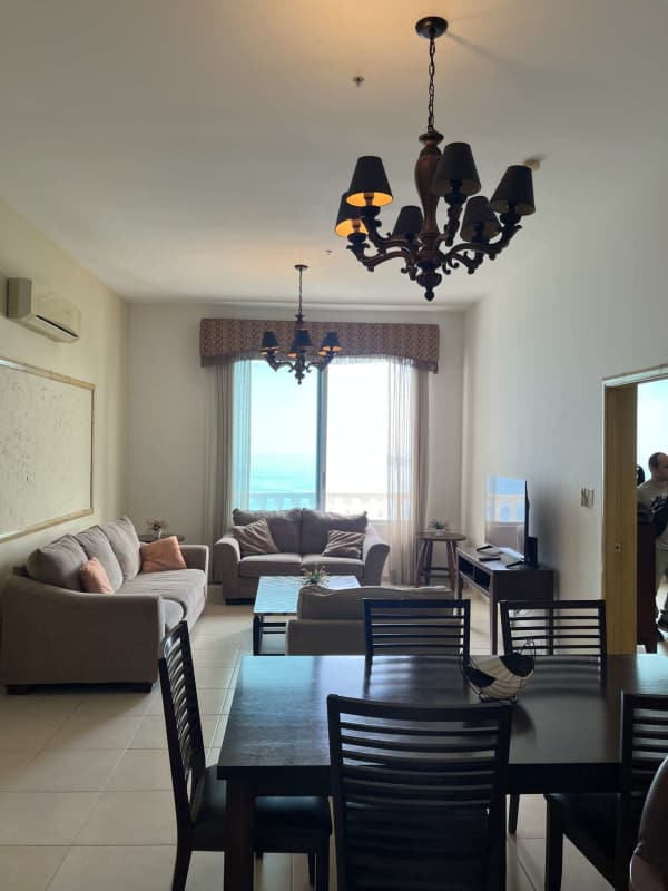 Bedroom with large windows, ceiling fan, city skyline view in PH BICSA Tower Panama City furnished rental