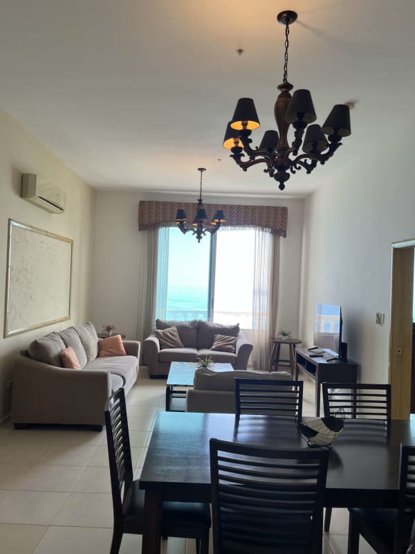 Open dining area with dark wood furniture, kitchen view in PH BICSA Tower furnished apartment Panama City