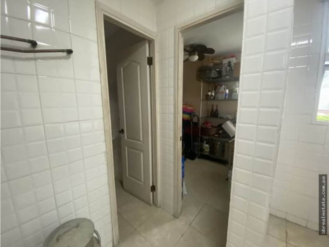 Modern balcony with glass dining table overlooking city PH Sunrise Tower