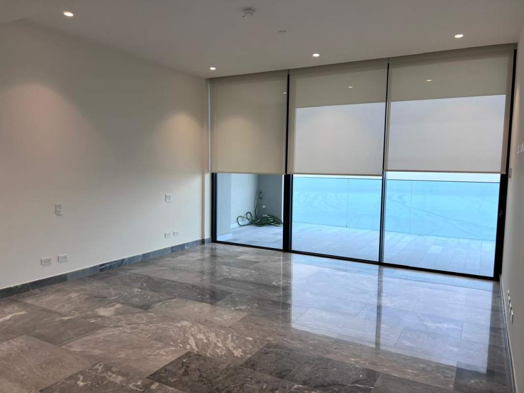 Luxury master bedroom with floor-to-ceiling window, marble floors and ocean view in PH Upper East Costa del Este Panama City