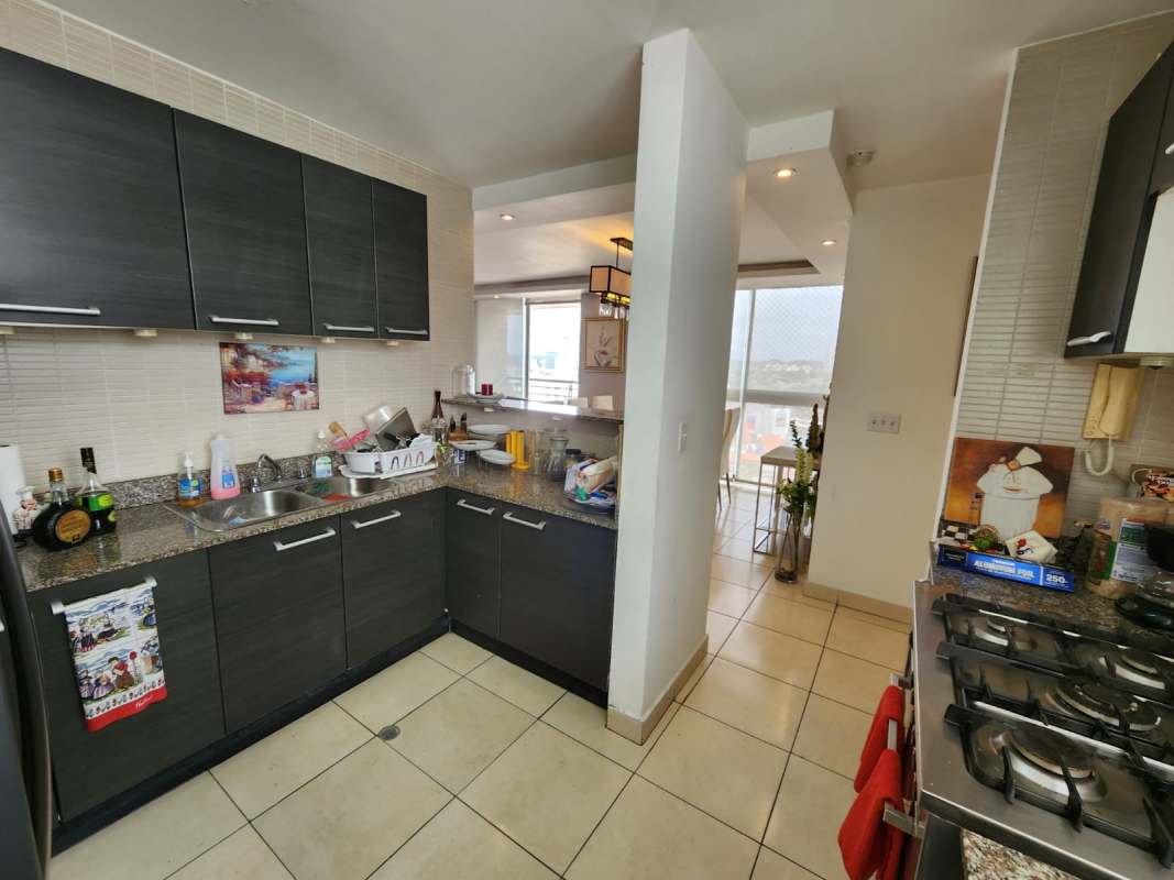 Kitchen with granite countertops, dark cabinets, tile backsplash in PH Ecco Tower Panama City