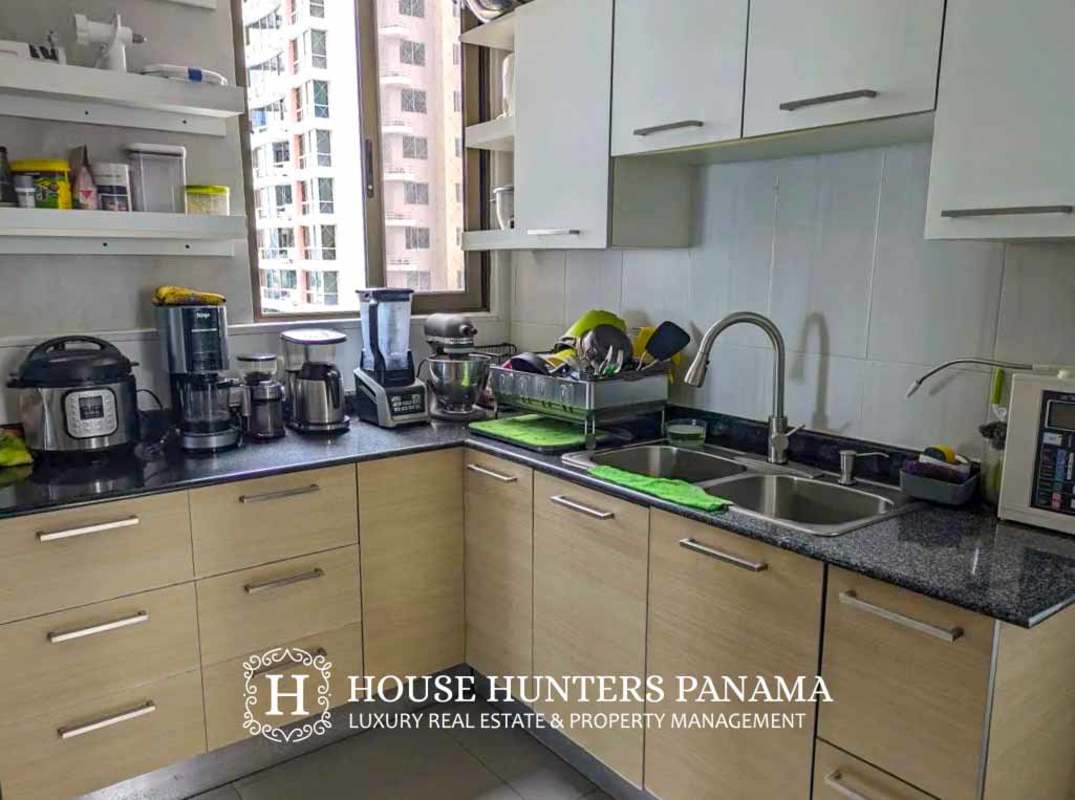 Modern dining room with marble walls and large window with city vista in luxury condo Panama