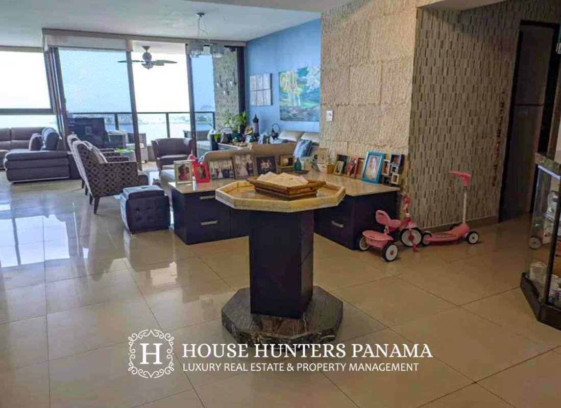 Living room with entertainment area, flat screen TV, stone accent wall in PH San Francisco Bay Panama City