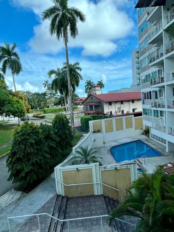 Outdoor swimming pool with palm trees, landscaped gardens at PH Sun City Clayton Albrook Panama