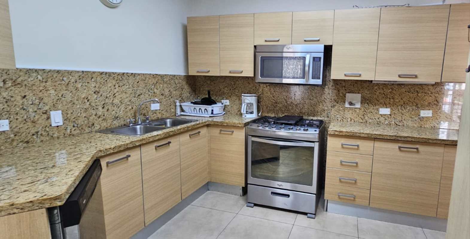 Granite countertops, stainless steel appliances, wooden cabinets in Embassy Village Apartment Panama City