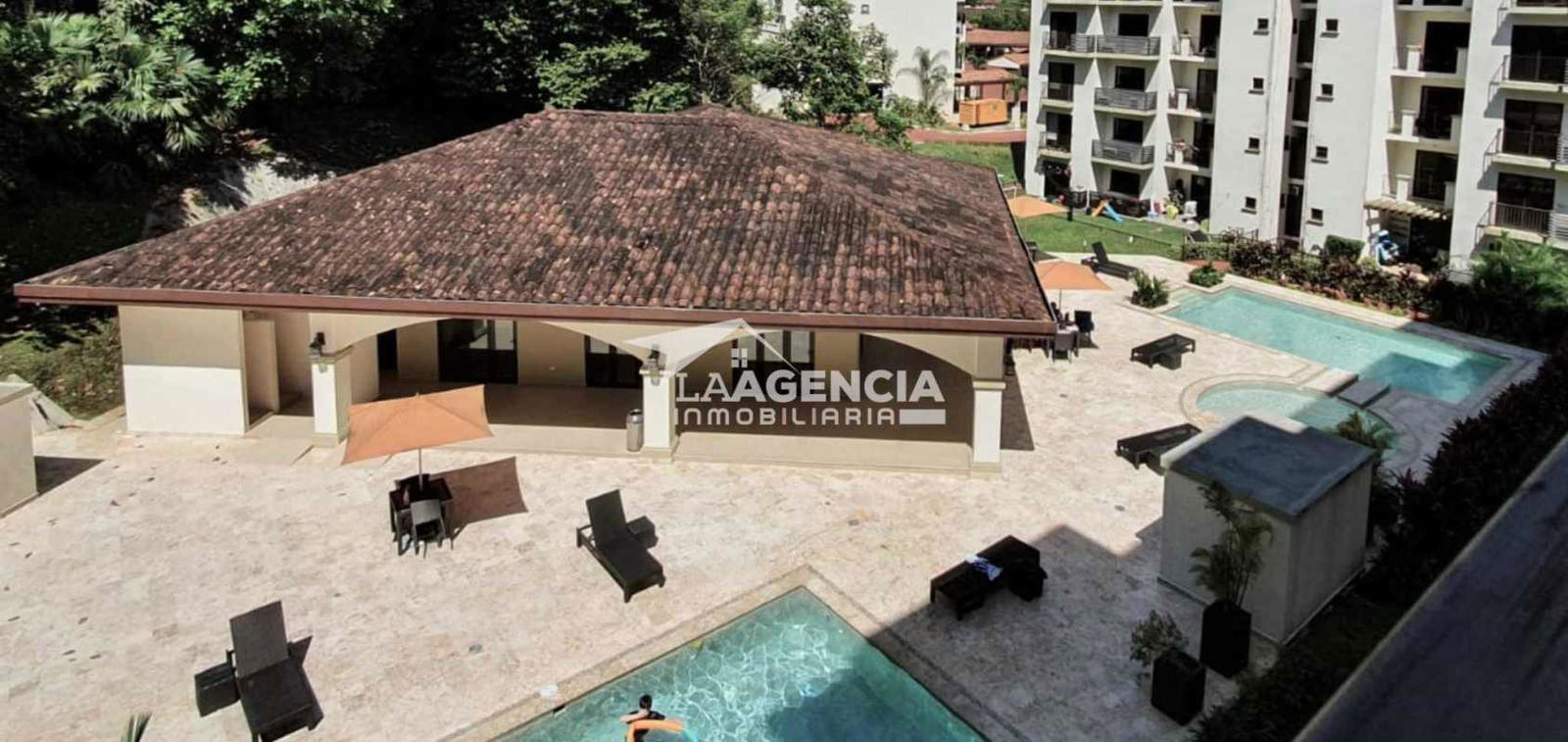 Resort-style swimming pool gardens Embassy Village residential community Clayton Panama