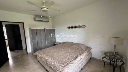 Living room with tile floor, AC, ceiling fan and large windows in San Carlitos home David