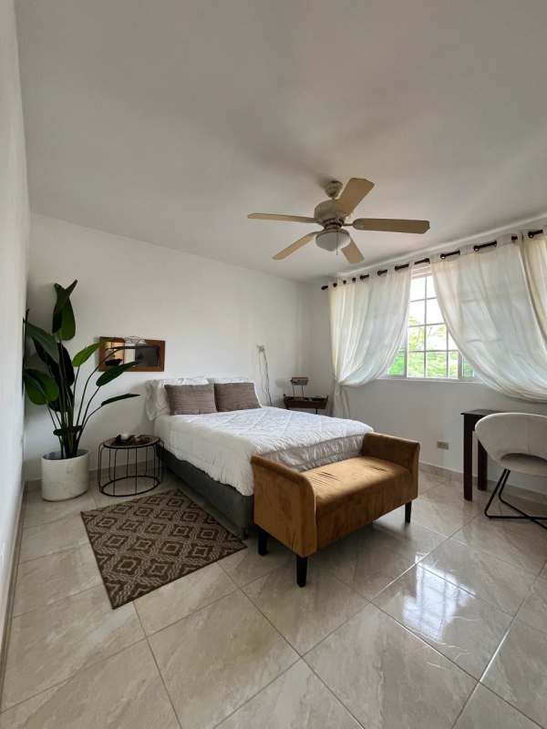 Bright bedroom with ceiling fan, large window and ceramic floor in Mirador Hill Villa Lucre Panama