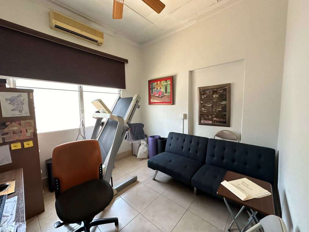 Large concrete patio with green area and fenced yard in Panama City San Francisco house for sale