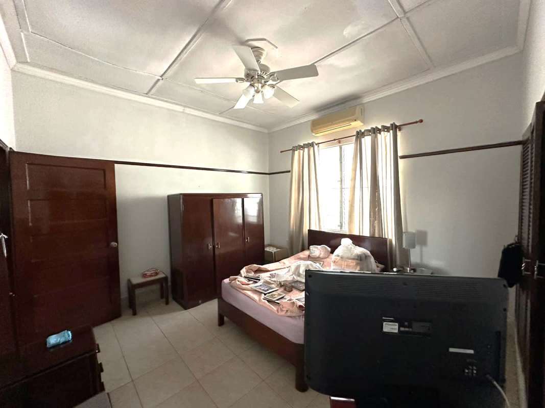 Spacious bedroom with air conditioner, tiled floor, large window, wooden wardrobe in San Francisco house for sale