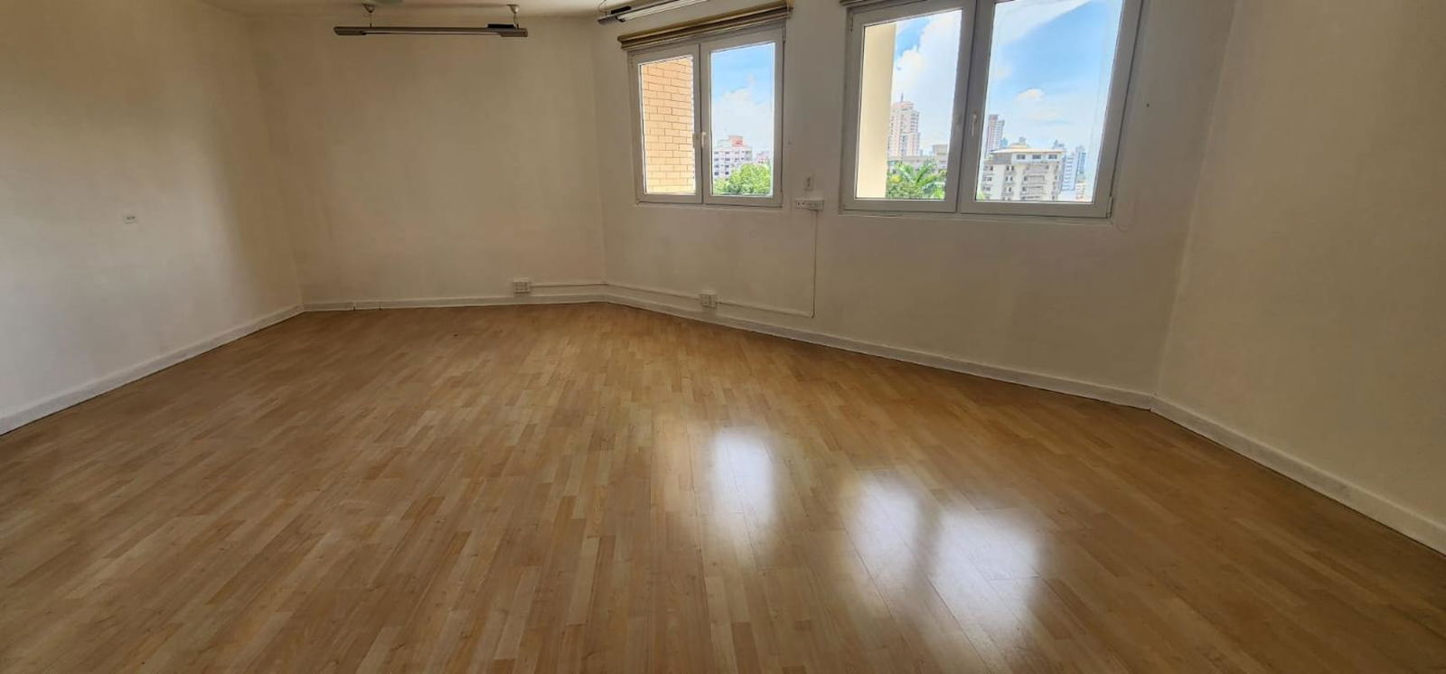 Spacious empty living room with large windows hardwood floors PH Vistanova Panama