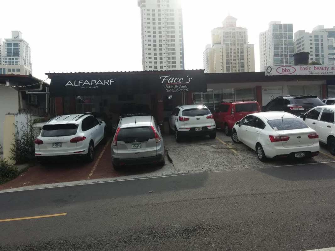 View of paved road fronting commercial residential development site with urban utilities Panama