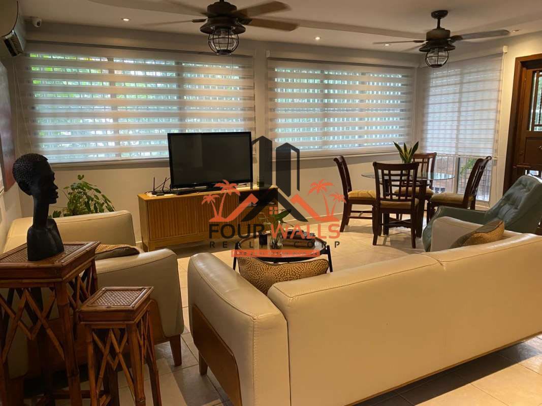Living room with cream sofas, large windows, tile flooring in Condado del Rey Panama house
